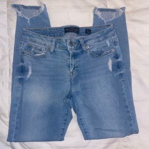 Mid-Rise Distressed Skinny Jeans.